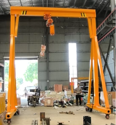 Mobile light gantry crane with electric hoist in a workshop