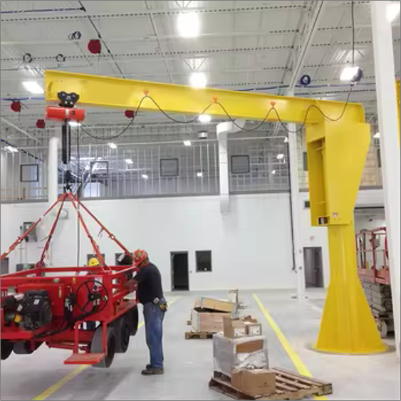 Freestanding pillar jib crane lifting equipment in an industrial workshop