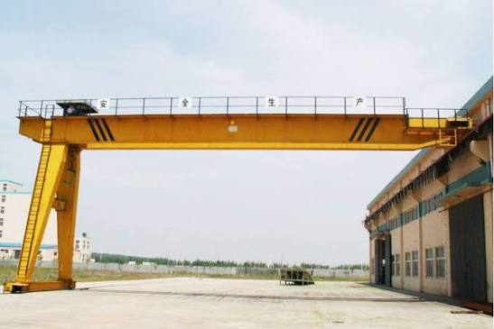 Double girder semi gantry crane inside an industrial workshop
