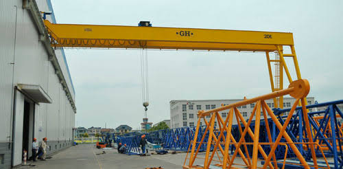 Heavy semi gantry crane installed beside a workshop