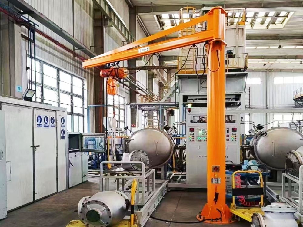 Pillar-mounted jib crane installed at an industrial workstation